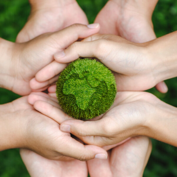 hands in a circle, holding a ball that represents a circle and is green